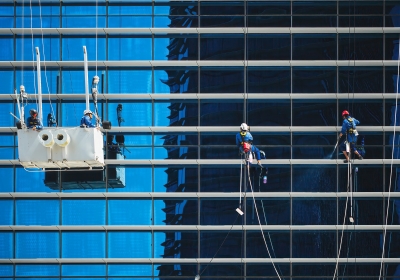 Glasbewassing door glazenwassers op grote hoogte bij een gevel